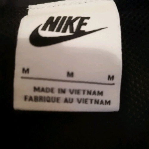 Nike unisex jacket used with colorful letters and small tear