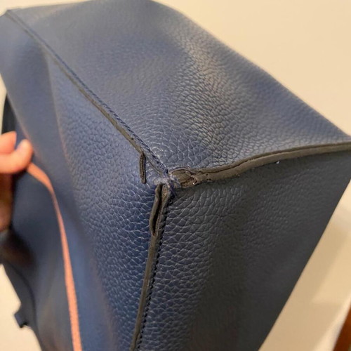 Blue shoulder bag used with brown details