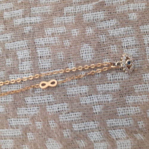 Short necklace with eye and infinity symbol new, gold color