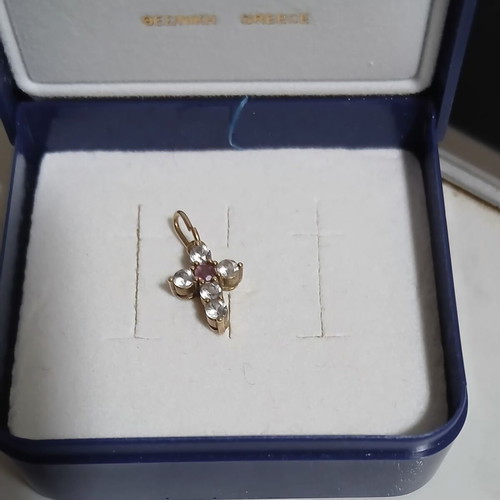 Gold cross 14K used with 5 zircon stones and 1 central ruby