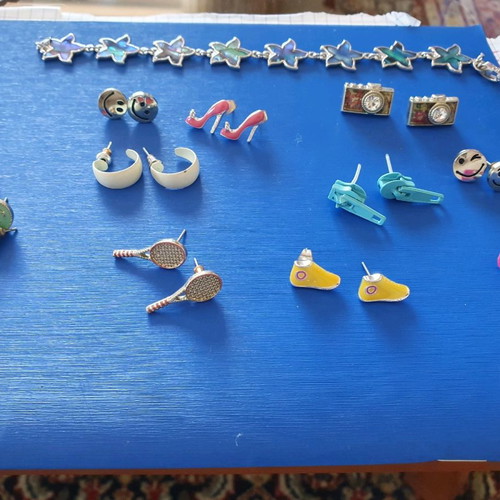 Unique earrings used with designs of swimsuits, rackets, sunglasses