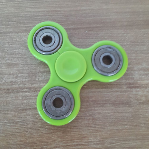 Fidget spinner used, metal with wear