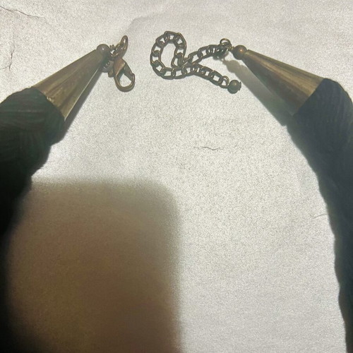 Iconic necklace with woven base and stone decoration