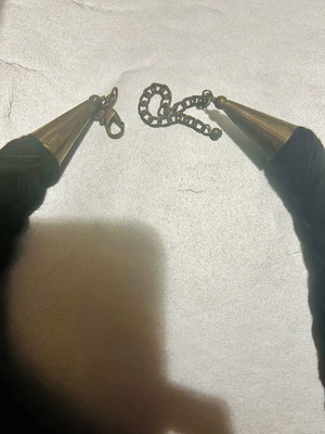 Iconic necklace with woven base and stone decoration