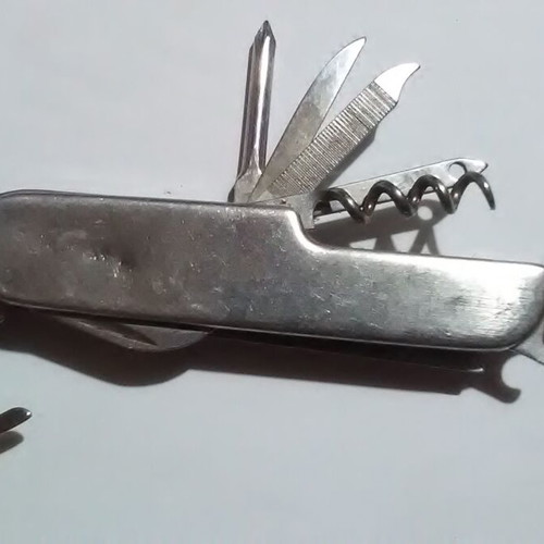 Swiss multi-tool knife with metal handle and multiple tools