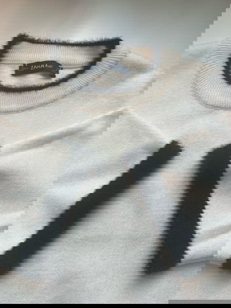 woman’s sweater cream color with black detail