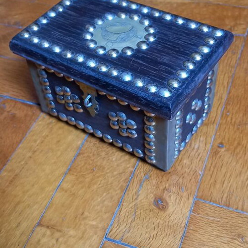 Decorative small wooden chest used with metal details