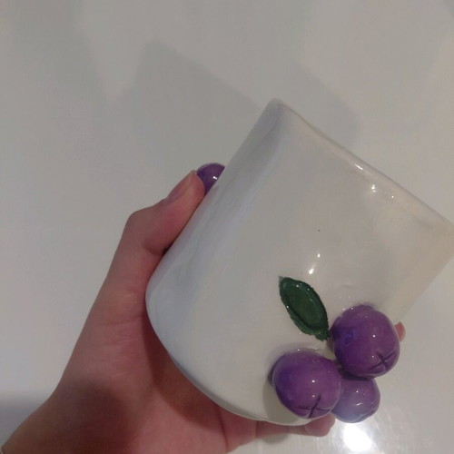 Soy candle with sandalwood scent in handmade ceramic cup