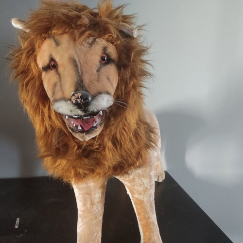Large realistic stuffed lion used with sturdy frame