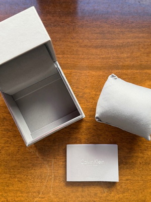 Calvin Klein empty watch box used with pillow and paper