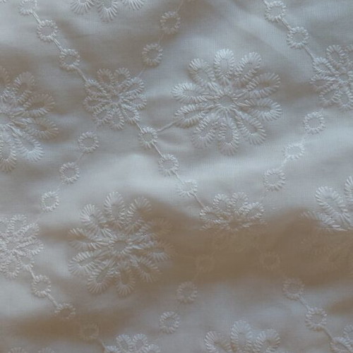 White sleeveless blouse with embroidered flowers