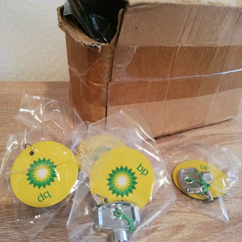 BP Bleed Keys Keychains like new, box with about 100 pieces