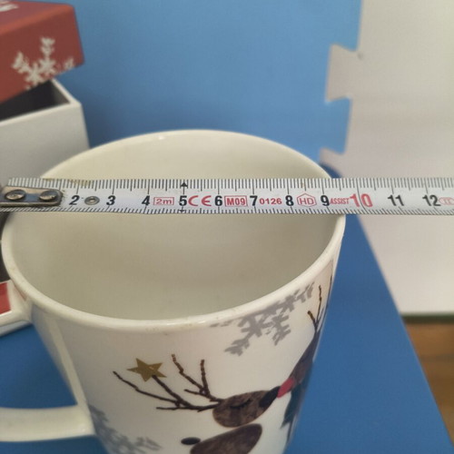 Christmas-themed mug with two reindeer