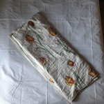 Single quilt used, white with floral patterns