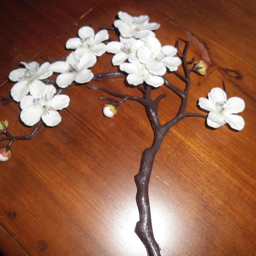 White orchid and black plastic vase shaped like female bust