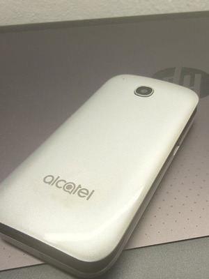 Alcatel mobile phone, silver, memory card slot