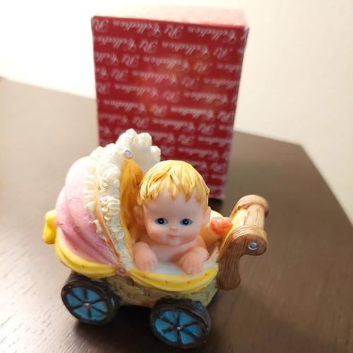 Decorative collectible baby stroller with baby and bottle like new