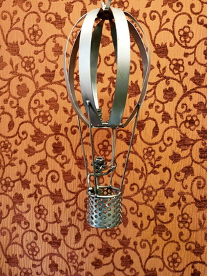 Hot air balloon used with figure made of nuts and bolts, metal sculpture