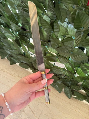Vintage serving knife used with metal handle and gold details