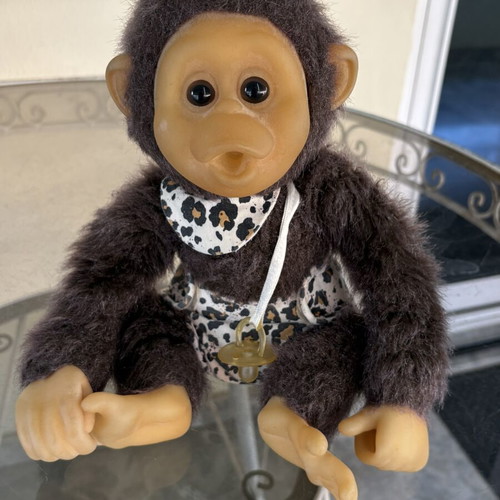Vintage plush monkey toy with sound and hanging feature