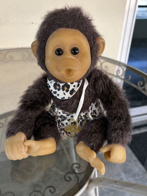Vintage plush monkey toy with sound and hanging feature