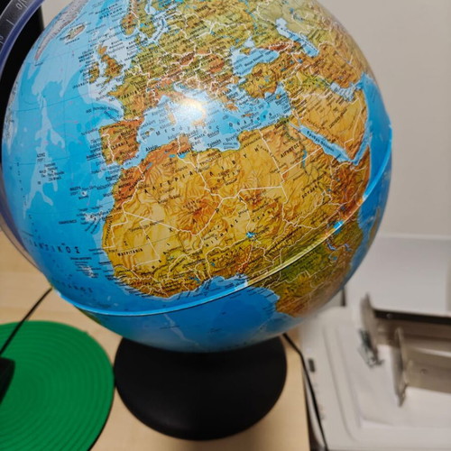 Illuminated world political map with Greek descriptions like new
