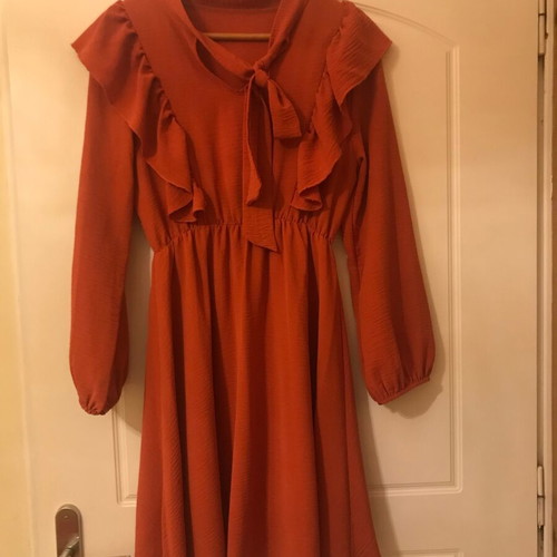 Coral dress like new with ruffles and front frill