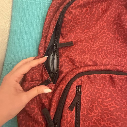 Nike backpack with one broken zipper, like new, black and red
