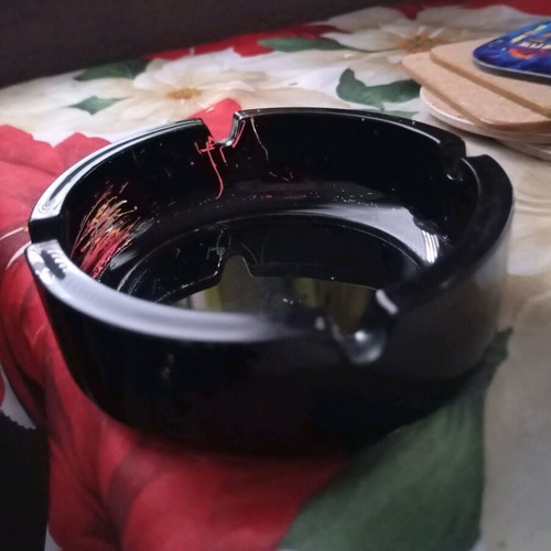 Glass ashtray vintage black classic with four cigarette slots used