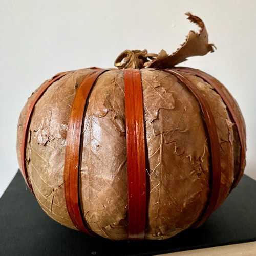 Decorative pumpkin wrapped with dried leaves like new