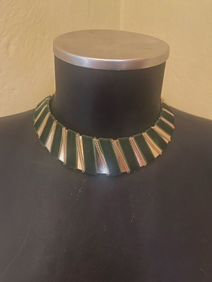 Gold necklace used with green velvet