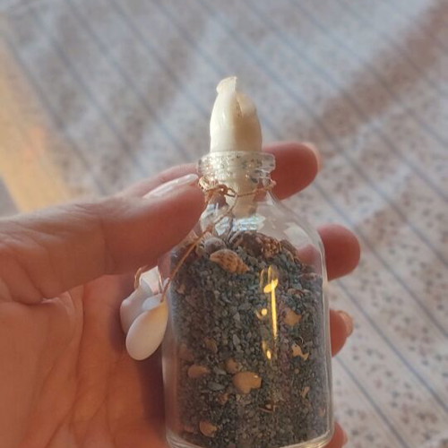 Glass bottle like new with shells and colorful sand