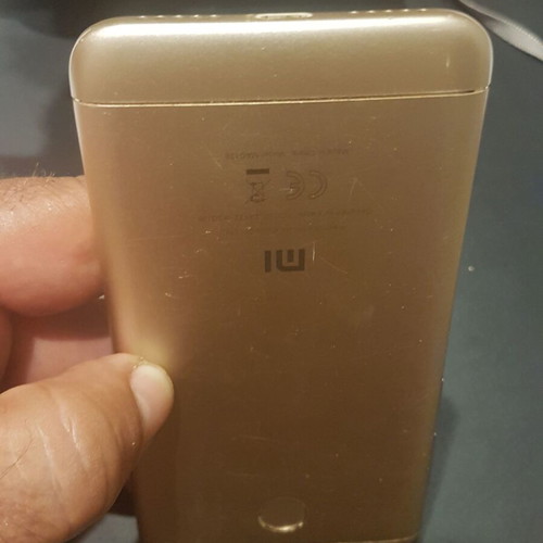 Xiaomi Redmi 4X smartphone with cracked screen, gold