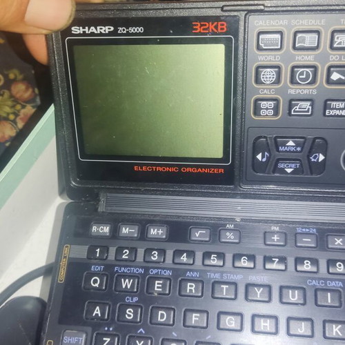 Collection of 6 handheld calculators including Casio, Sharp, and guitar tuner