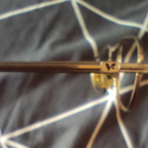 Vogue eyeglass frame used, gold color