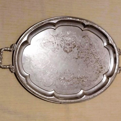 Silver-plated serving tray used with ornate handles