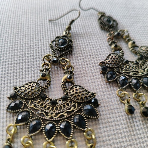 Long metal earrings used, black and gold
