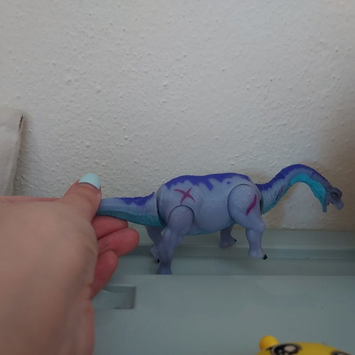 Dinosaur toy like new, purple with movable head and tail
