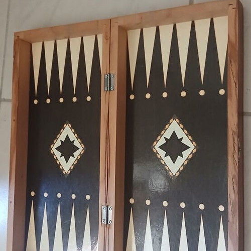 Chessboard with pieces and backgammon