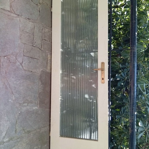 Interior wooden door with glass and gold handle