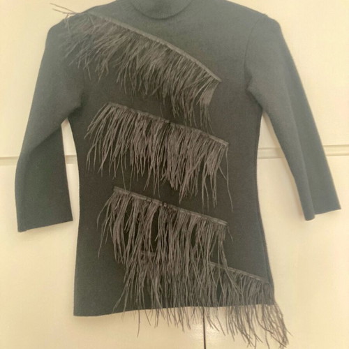 Zini black turtleneck like new, size small, with feathers and back opening