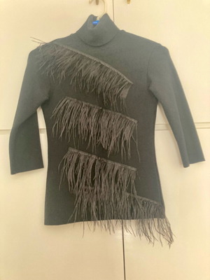 Zini black turtleneck like new, size small, with feathers and back opening
