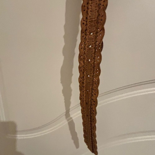 Tan belt like new with wavy edges and metal buckle