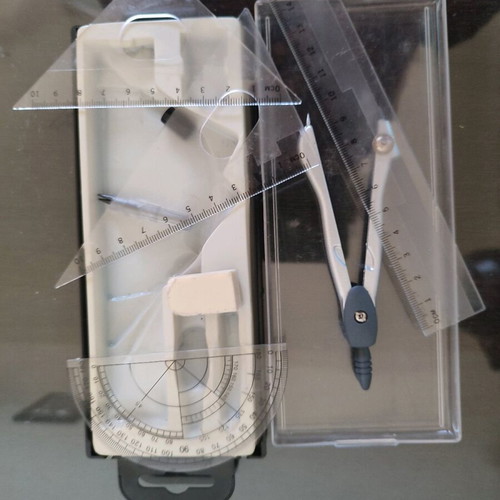 Geometry set like new with compass, protractor, ruler, and pencil