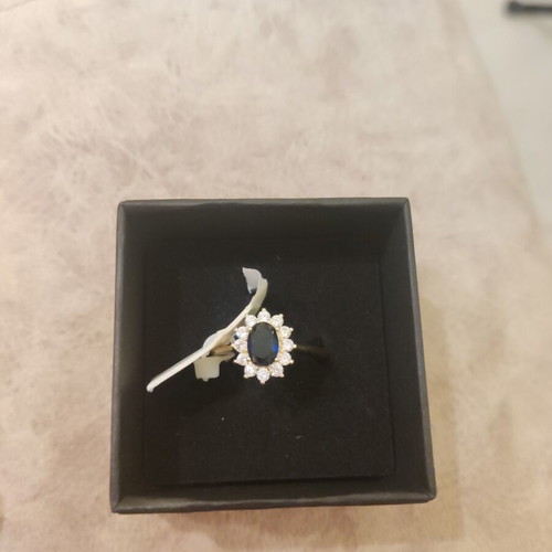 Women's rosetta ring new, gold color with blue oval stone and zircons