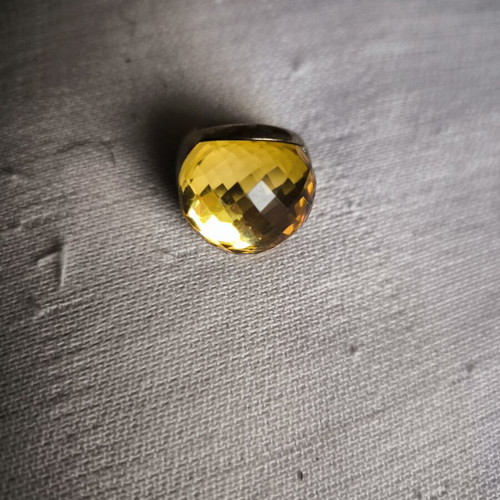 Statement ring with thick honey-colored glass on gold metal, used