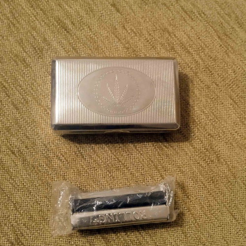 Tobacco case and metal cigarette roller used