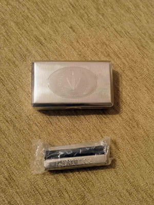 Tobacco case and metal cigarette roller used