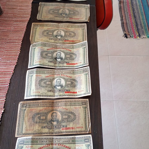 Old collectible banknotes used, 7 of 1000 drachmas and 4 of 500 drachmas