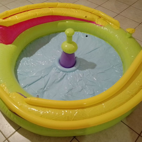 Inflatable colorful playpen used with balls and slides